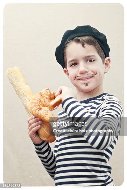 boy holding baguette and croissant - french croissant stock pictures, royalty-free photos & images