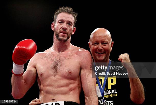 Enzo Maccarinelli celebrates with trainer Dean Powell after his victory over Ciaran Healy in their Cruiserweight bout at the Motorpoint Arena on...