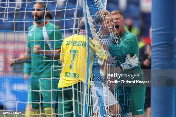 Julius Paris of Straelen celebrates with his team mates after saving a penalty during the State Cup Final Lower Rhine between SV Straelen and...