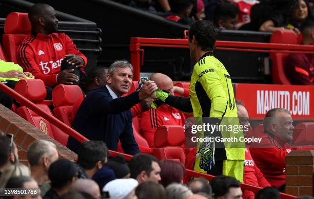 Manchester United manager Bryan Robson shakes hands with Raimond van der Gouw during the Legends of the North match between Manchester United and...