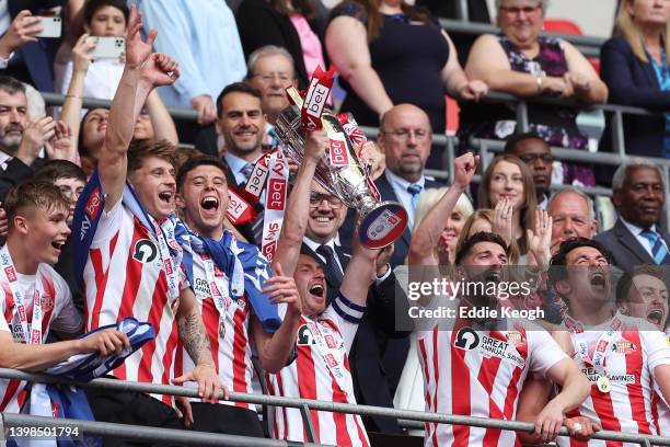 Corry Evans of Sunderland lifts the Sky Bet League One Play-Off trophy following victory in the Sky Bet League One Play-Off Final match between...