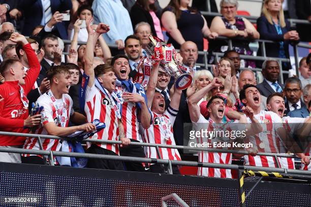 Corry Evans of Sunderland lifts the Sky Bet League One Play-Off trophy following victory in the Sky Bet League One Play-Off Final match between...