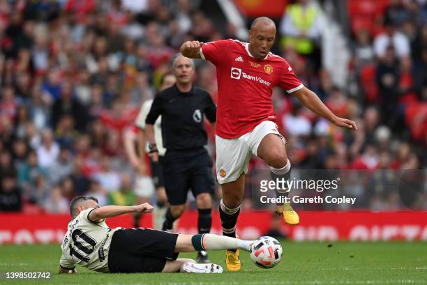 Mikael Silvestre of Manchester United is tackled by Luis Garcia of Liverpool during the Legends of the North match between Manchester United and...