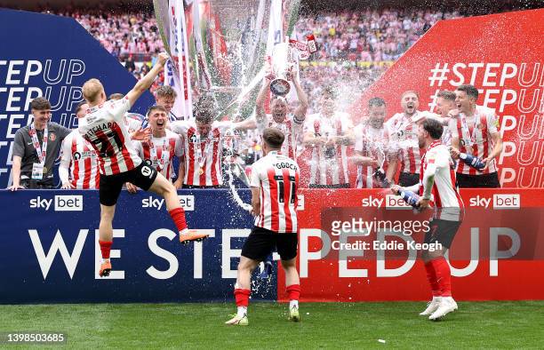 Corry Evans of Sunderland lifts the Sky Bet League One Play-Off trophy following victory in the Sky Bet League One Play-Off Final match between...