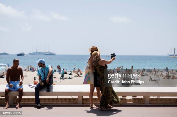 Beachgoers soak up the sunshine during the 75th annual Cannes film festival on May 21, 2022 in Cannes, France.