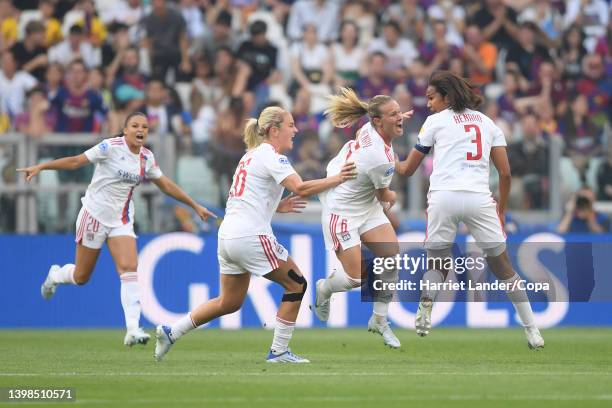 Amandine Henry of Olympique Lyon celebrates with teammates Lindsey Horan and Wendie Renard after scoring her team's first goal during the UEFA...