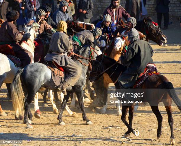 buzkashi match scrum - several players fight for the calf, mazar-e-sharif, balkh province, afghanistan - persian new year stock pictures, royalty-free photos & images