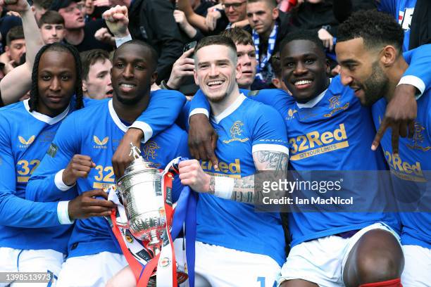 Joe Aribo, Glen Kamara, Ryan Kent, Calvin Bassey and Connor Goldson of Rangers pose with the trophy during the Scottish Cup Final match between...
