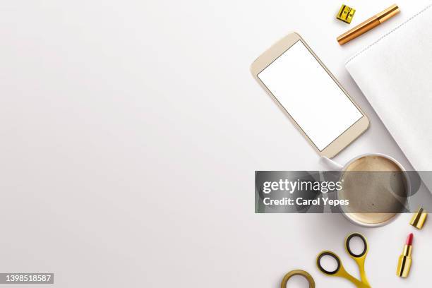 top view golden scissors, tulips, lipstick,  golden ring  hot coffee cup and  smartphone - mug mockup stock pictures, royalty-free photos & images