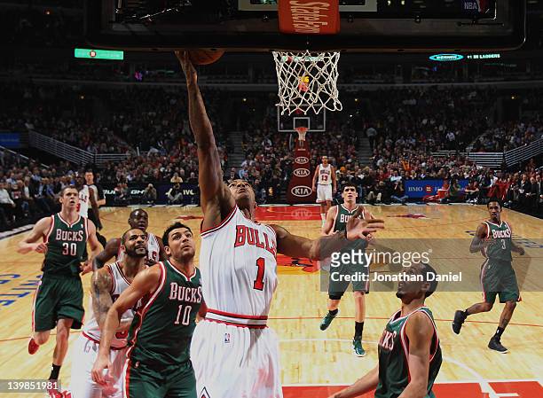 Derrick Rose of the Chicago Bulls puts up a shot over Carlos Delfino and Shaun Livingston of the Milwaukee Bucks at the United Center on February 22,...