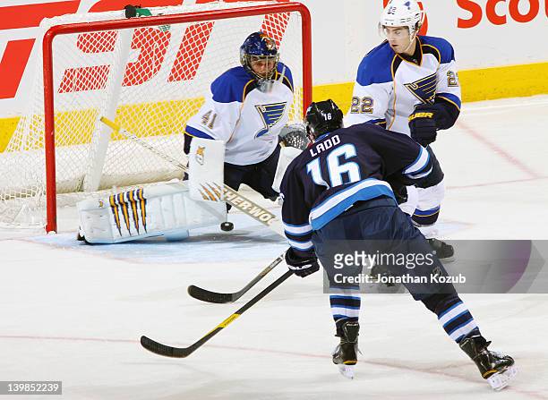 Andrew Ladd of the Winnipeg Jets gets a shot on goaltender Jaroslav Halak of the St. Louis Blues as defenseman Kevin Shattenkirk of the Blues watches...