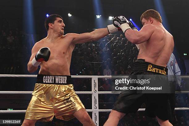 Marco Huck of Germany punches Alexander Povetkin of Russia during the WBA World Championship Heavyweight fight between Marco Huck of Germany and...