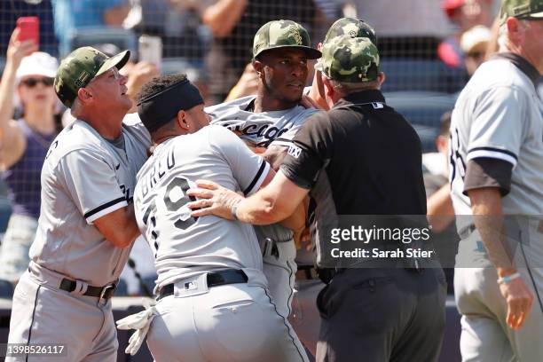 Jose Abreu holds back Tim Anderson of the Chicago White Sox after a benches-clearing dispute between Yasmani Grandal of the Chicago White Sox and...