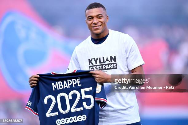 Kylian Mbappé poses with his jersey after extending his contract with the PSG prior to the Ligue 1 Uber Eats match between Paris Saint Germain and...