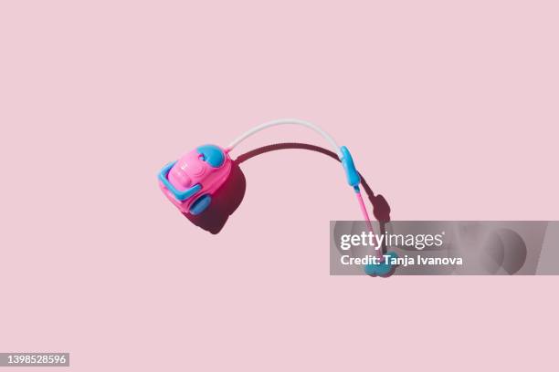 toy vacuum cleaner on pink background. cleaning services concept - dammsugare bildbanksfoton och bilder