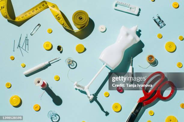 tailoring scissors and sewing supplies and accessories on blue background - button craft stock pictures, royalty-free photos & images