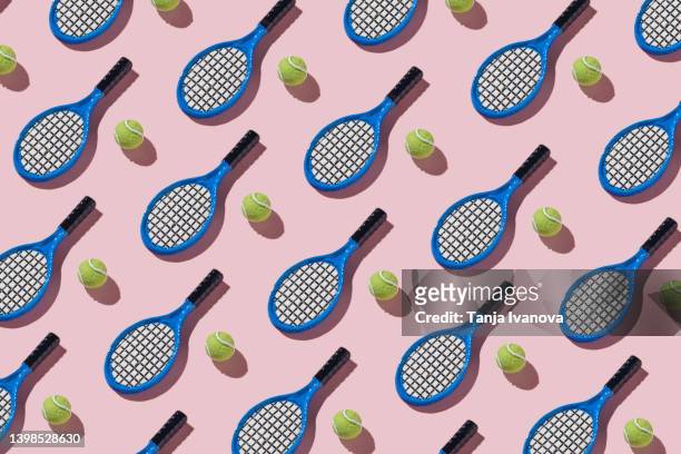 tennis rackets and balls on pink background - tennis racquet isolated stock pictures, royalty-free photos & images