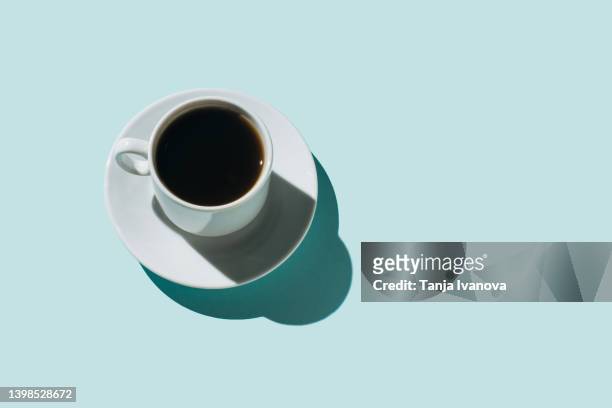 coffee cups on a blue background with an copy space for design - tazzina foto e immagini stock