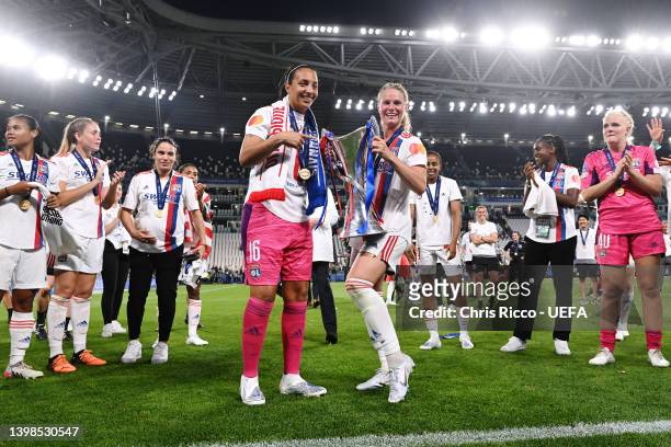 Sarah Bouhaddi and Eugenie Le Sommer of Olympique Lyonnais celebrate with the UEFA Women's Champions League trophy after their sides victory during...