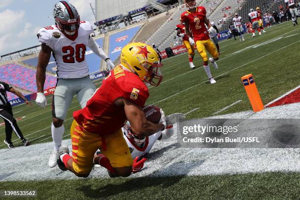 Matt Colburn II of the Philadelphia Stars is pushed out of bounds by Obi Melifonwu and Rannell Hall of the Tampa Bay Bandits in the second quarter of...