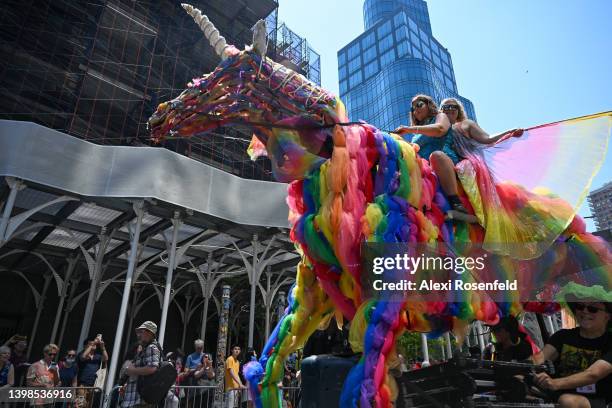 People ride a large unicorn during the 16th annual Dance Parade on May 21, 2022 in New York City. The dance parade returned this year after being...