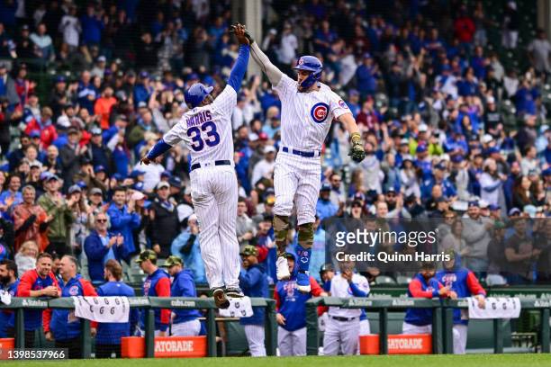 Patrick Wisdom of the Chicago Cubs and Willie Harris of the Chicago Cubs celebrate after the home run in the second inning against the Arizona...