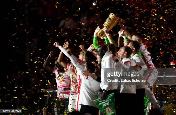 Peter Gulacsi of RB Leipzig lifts the DFB Cup trophy following victory in the final match of the DFB Cup 2022 between SC Freiburg and RB Leipzig at...