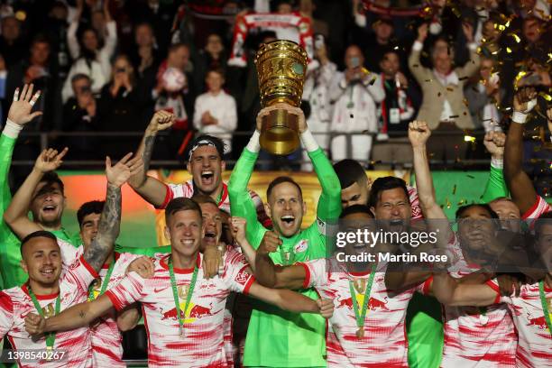 Peter Gulacsi of RB Leipzig lifts the DFB-Pokal trophy after their sides victory during the final match of the DFB Cup 2022 between SC Freiburg and...