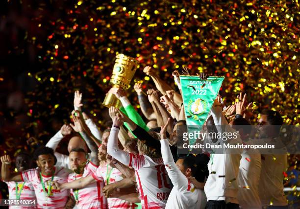 Peter Gulacsi of RB Leipzig lifts the DFB-Pokal trophy after their sides victory during the final match of the DFB Cup 2022 between SC Freiburg and...