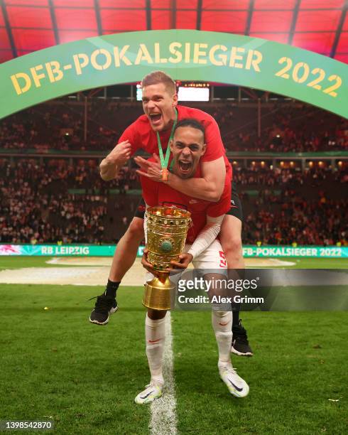 Marcel Halstenberg and Yussuf Poulsen of RB Leipzig celebrate with the DFB-Pokal trophy after their sides victory during the final match of the DFB...