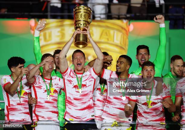 Marcel Halstenberg of RB Leipzig lifts the DFB-Pokal trophy after their sides victory during the final match of the DFB Cup 2022 between SC Freiburg...