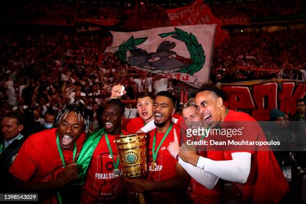 Benjamin Henrichs and teammates, Mohamed Simakan, Amadou Haidara, Emil Forsberg and Yussuf Poulsen of RB Leipzig celebrate with the DFB Cup trophy...