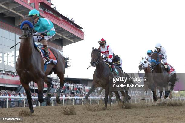 Jockey Jose Ortiz rides Early Voting into the first turn during the 147th Running of the Preakness Stakes at Pimlico Race Course on May 21, 2022 in...