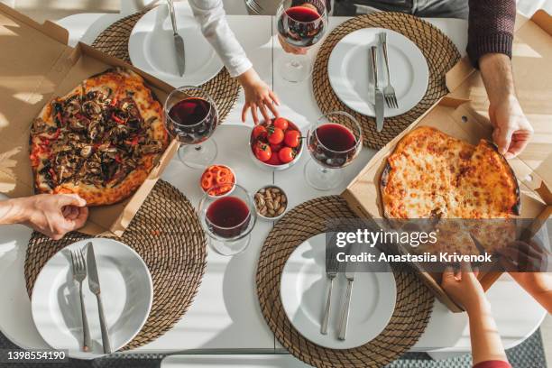 people hands grabbing pizza from delivery box. - wine home delivery stock pictures, royalty-free photos & images