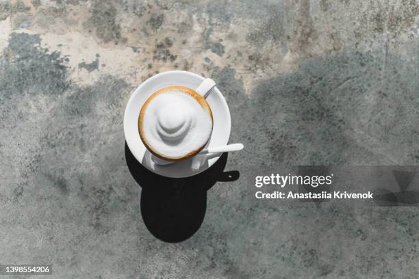 cup of cappuccino coffee on concrete table. - coffee drink white background stock pictures, royalty-free photos & images