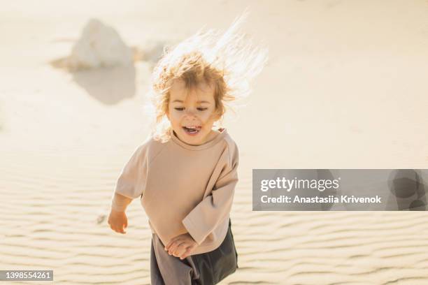 little girl having fun in the desert. - abu dhabi people stock pictures, royalty-free photos & images