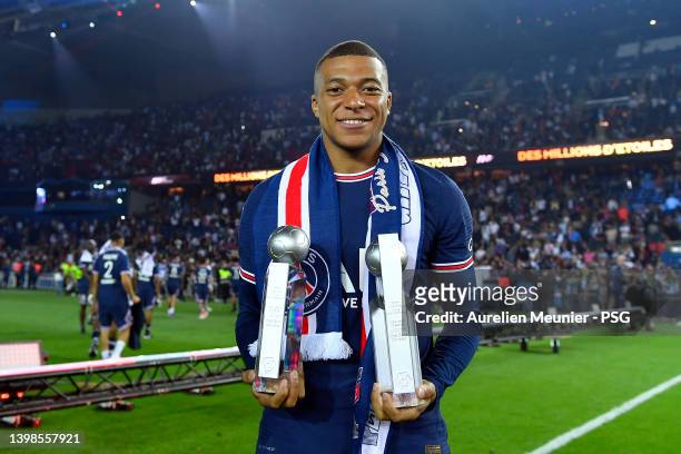 Kylian Mbappe of Paris Saint-Germain poses with the best scorer and best passer trophies after the Ligue 1 Uber Eats match between Paris Saint...