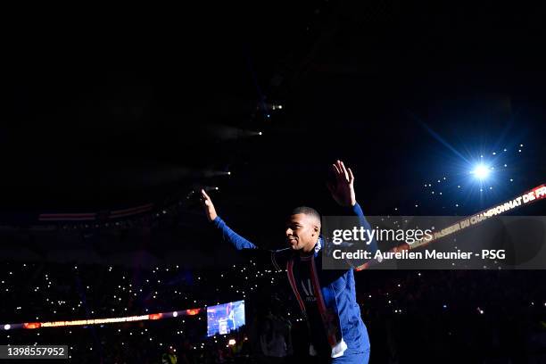 Kylian Mbappe walks to the center of the pitch for the trophy celebration after the Ligue 1 Uber Eats match between Paris Saint Germain and FC Metz...