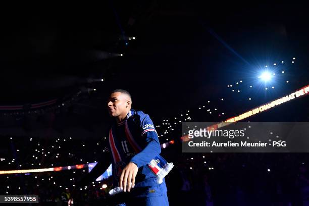 Kylian Mbappe walks to the center of the pitch for the trophy celebration after the Ligue 1 Uber Eats match between Paris Saint Germain and FC Metz...