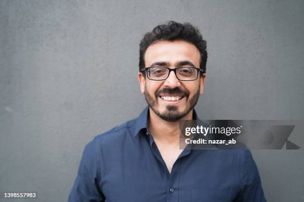 man with toothy smile looking to camera. - pakistani ethnicity stock pictures, royalty-free photos & images