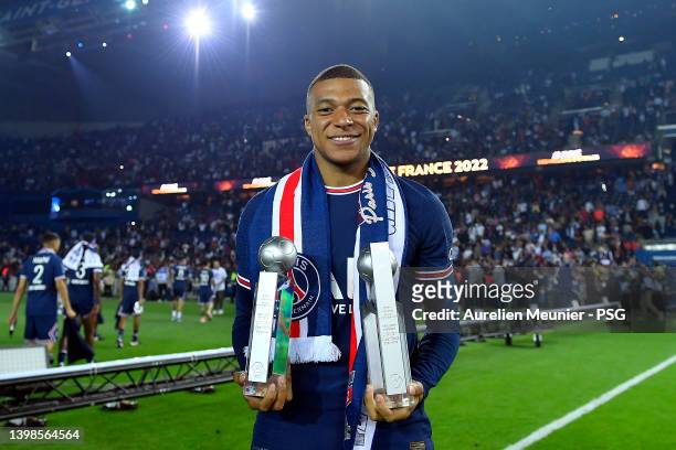 Kylian Mbappe of Paris Saint-Germain poses with the best scorer and best passer trophies after the Ligue 1 Uber Eats match between Paris Saint...