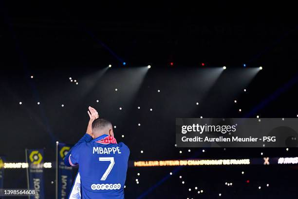 Kylian Mbappe walks to the center of the pitch for the trophy celebration after the Ligue 1 Uber Eats match between Paris Saint Germain and FC Metz...