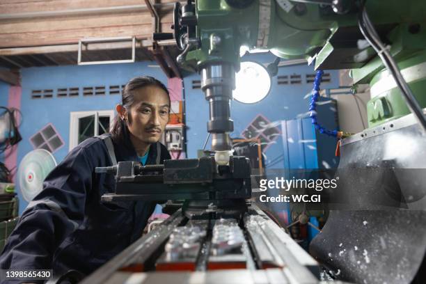 small business owner works on a milling machine - milling stock pictures, royalty-free photos & images