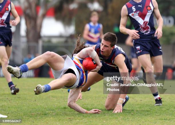 Nicholas Watson of the Rangers is tackled high by Ben Andrews of the Dragons during the NAB League Boys match between Sandringham and Eastern Ranges...