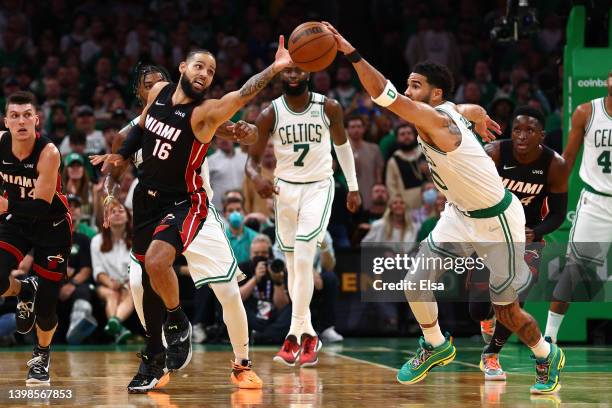 Jayson Tatum of the Boston Celtics and Caleb Martin of the Miami Heat compete for the ball in the third quarter in Game Three of the 2022 NBA...