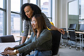 Woman mentoring a young employee in the office