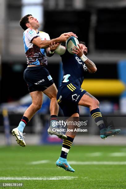 Ben Donaldson of the Waratahs and Denny Solomona of the Highlanders compete for the ball during the round 14 Super Rugby Pacific match between the...