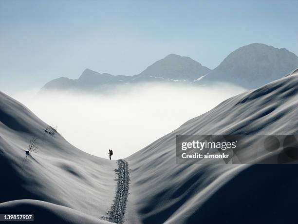 above the clouds - skier silhouette stock pictures, royalty-free photos & images