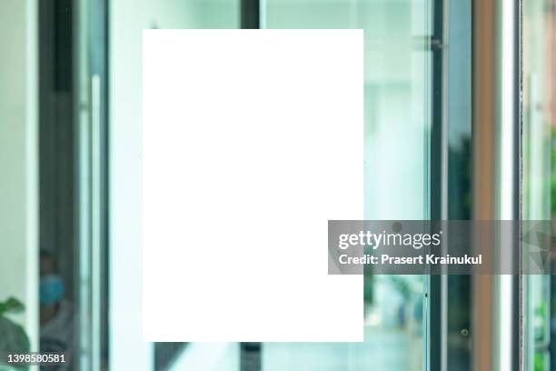 mockup a4 white paper or white promotion poster displayed on the front of bright office interior - billboard mockup stock-fotos und bilder