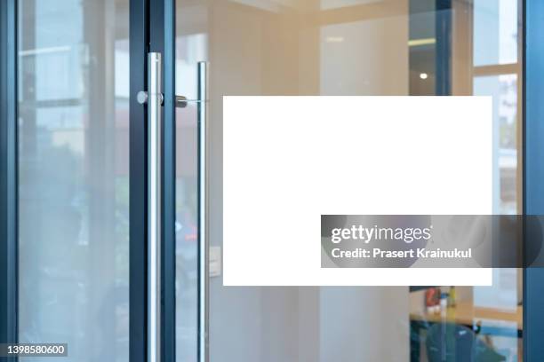 mockup a4 white paper or white promotion poster displayed on the front of bright office interior - office placard stock pictures, royalty-free photos & images